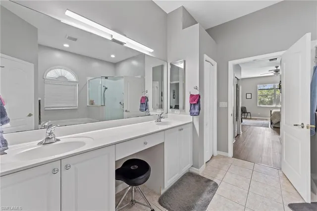 a spacious bathroom with a sink shower and a mirror