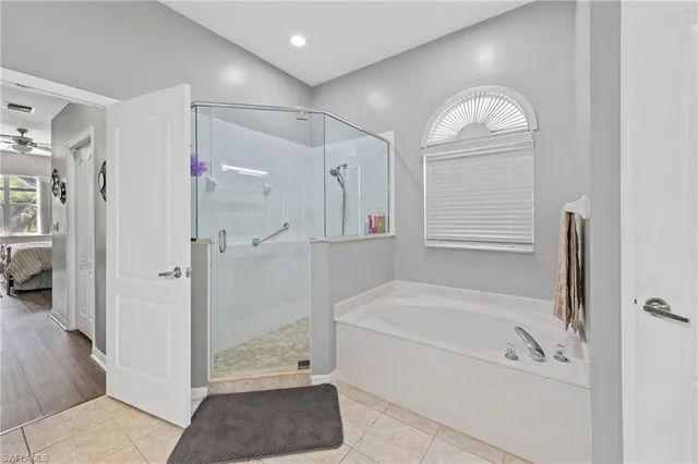 a bathroom with a tub a sink and a shower