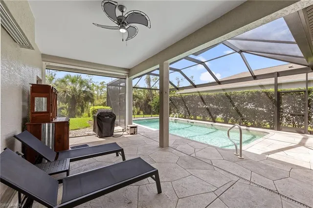 a living room with a fireplace furniture and a large window