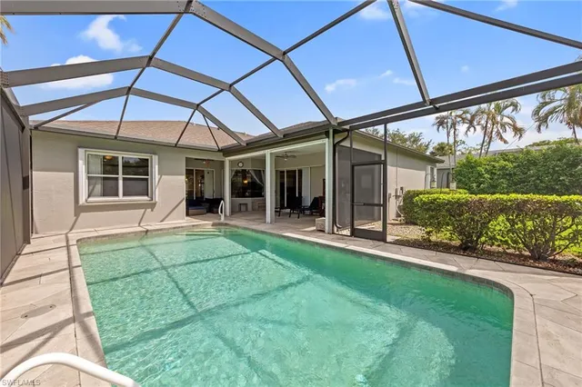 a view of a house with backyard porch and sitting area