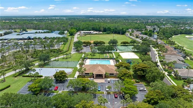 an aerial view of residential houses with outdoor space and street view