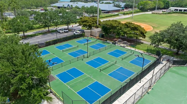 a view of aerial tennis pool yard and outdoor seating