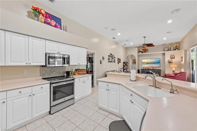 a kitchen with stainless steel appliances granite countertop a sink and cabinets