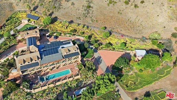 a bedroom with a bed and a large mirror