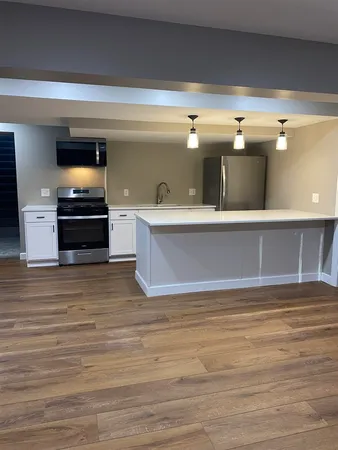 a living room with furniture and flat screen tv