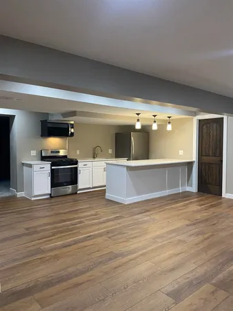 a view of a kitchen with a sink and a large window