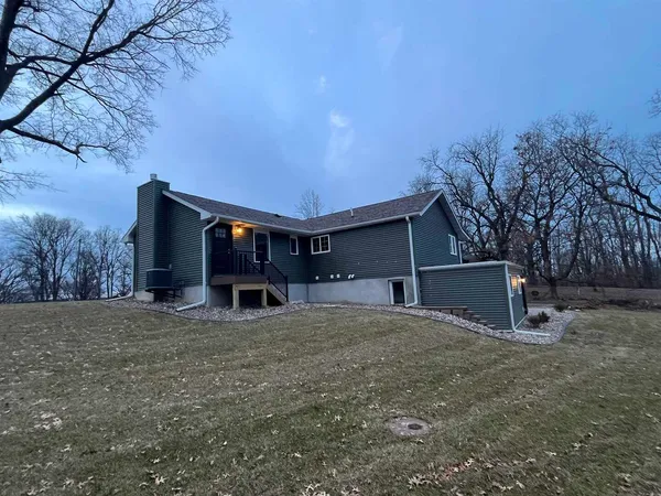 a view of a house with a yard and garage