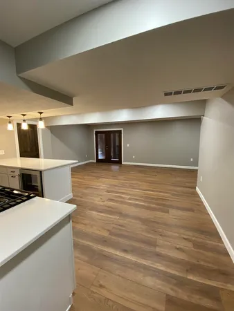 a room with wooden floor and white walls
