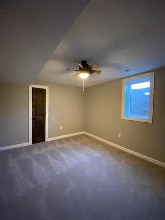 a view of an empty room with a ceiling fan