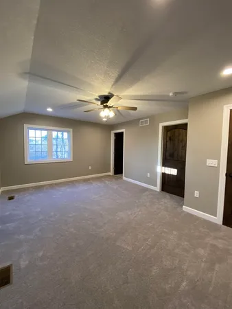 a view of a big room with windows and brick walls
