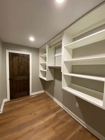 a view of an empty room with a fireplace and a window
