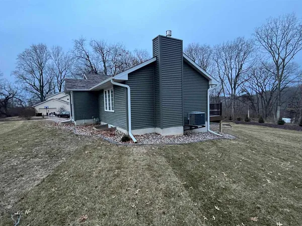 a view of a house with a yard and garage