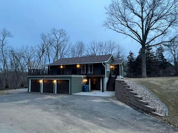 a view of house with outdoor space and parking