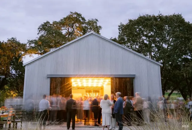 a backyard of a house with table and chairs