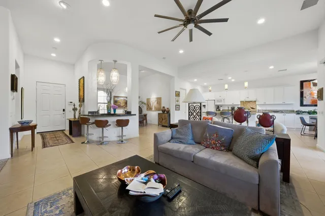 a living room with furniture and a view of kitchen
