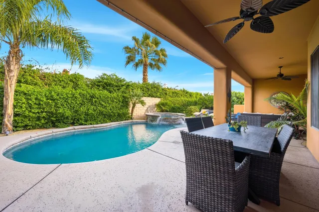 a view of a dining room with a table and chairs