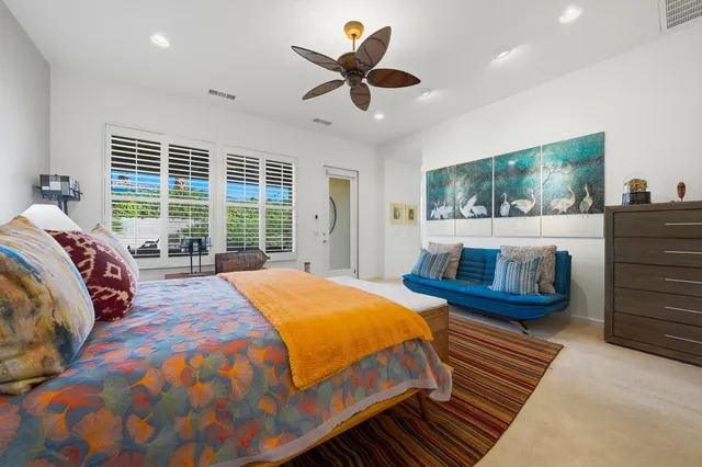 a bed sitting in a bedroom next to a window