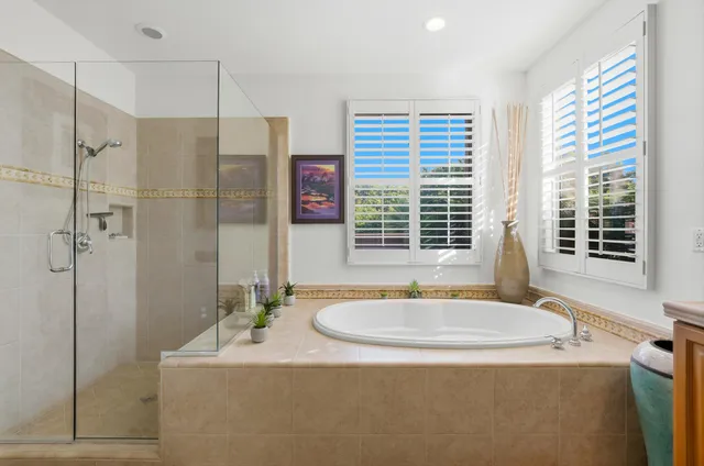 a bath tub sitting next to a bathroom sink