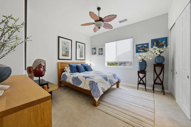 a bedroom with bed and a chandelier