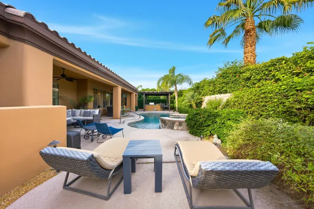 a view of a patio with table and chairs and potted plants