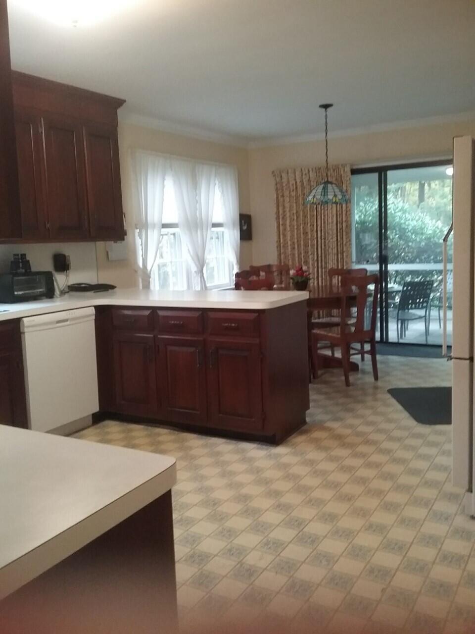 24 White Oak Shade Road New Canaan, CT 06840 - Photo 2 of 13 a room with wooden cabinets a sink dishwasher and a stove with wooden floor