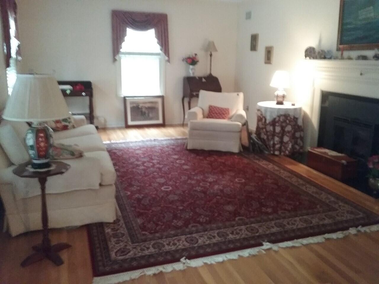 24 White Oak Shade Road New Canaan, CT 06840 - Photo 3 of 13 a living room with furniture a window and a fireplace