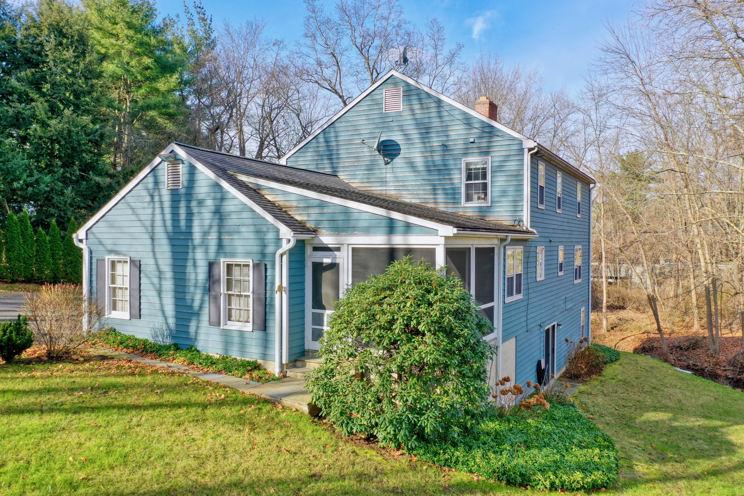 24 White Oak Shade Road New Canaan, CT 06840 - Photo 7 of 13 front view of a house with a yard