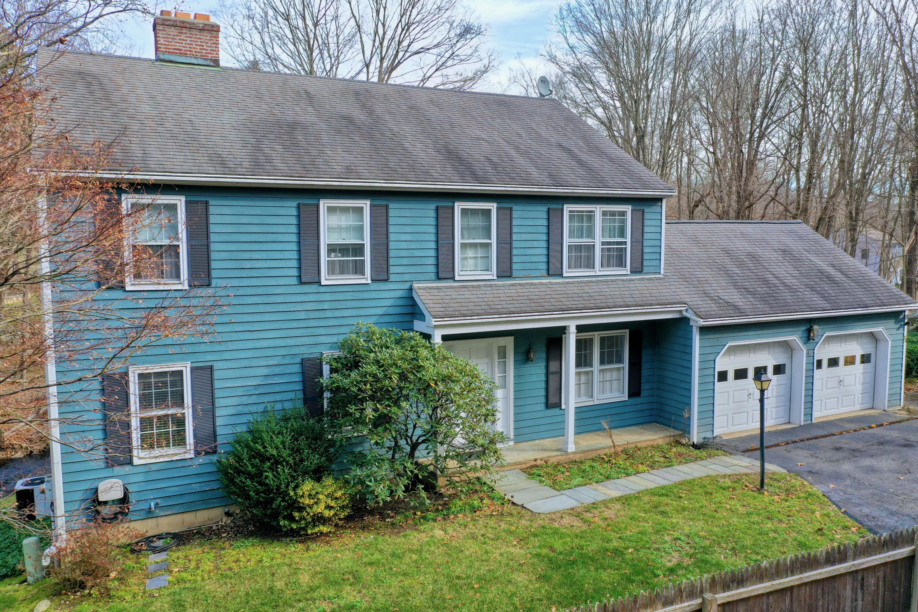 24 White Oak Shade Road New Canaan, CT 06840 - Photo 10 of 13 a front view of a house with garden