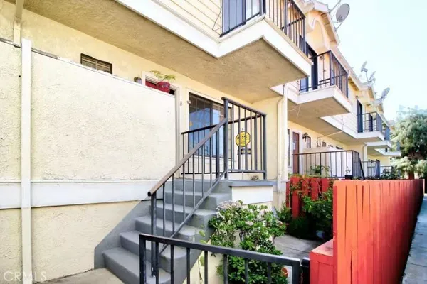 a view of a balcony with wooden floor and fence
