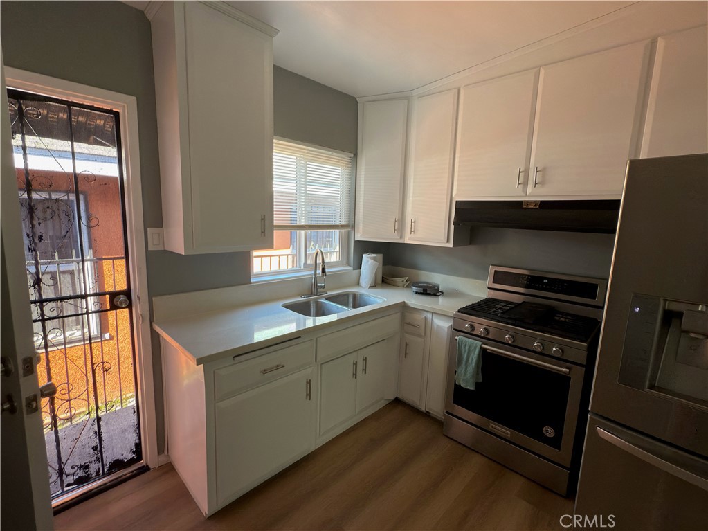 1735 Chestnut Avenue Long Beach, CA 90813 - Photo 6 of 13 a kitchen with a sink stove and cabinets