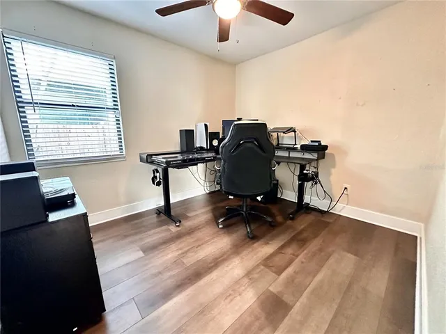 a view of workspace with wooden floor windows