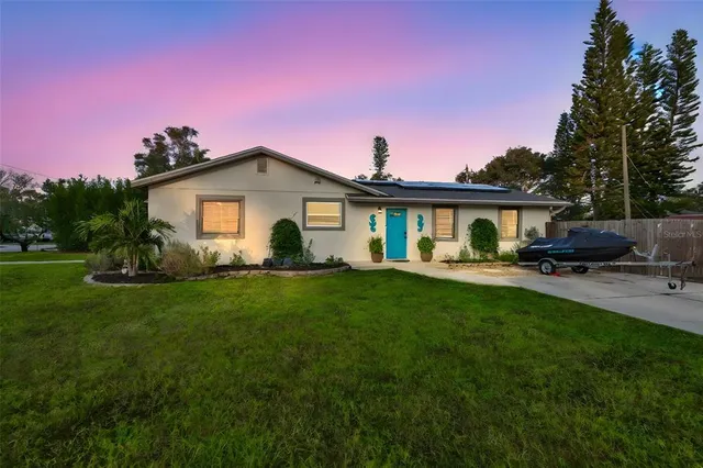 a front view of a house with a garden and yard