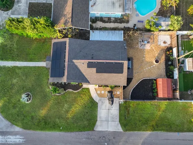 an aerial view of a house with a yard