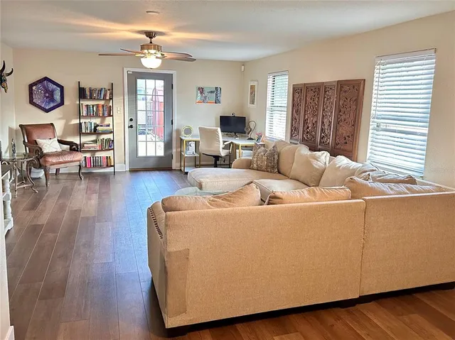 a living room with furniture and a wooden floor