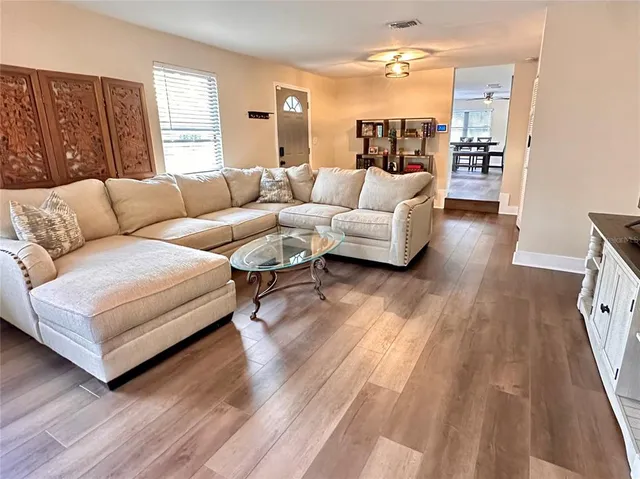 a living room with furniture and a large window