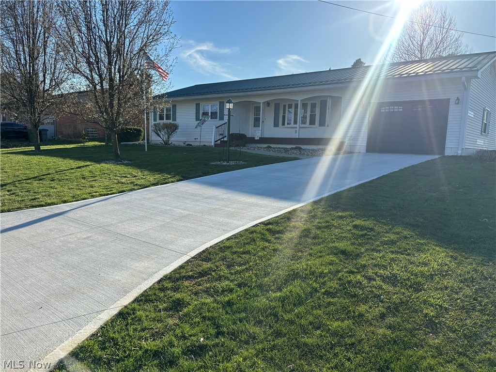 64197 Morrison Road Cambridge, OH 43725 - Photo 2 of 41 View of front of house with a front lawn, a garage, and a porch