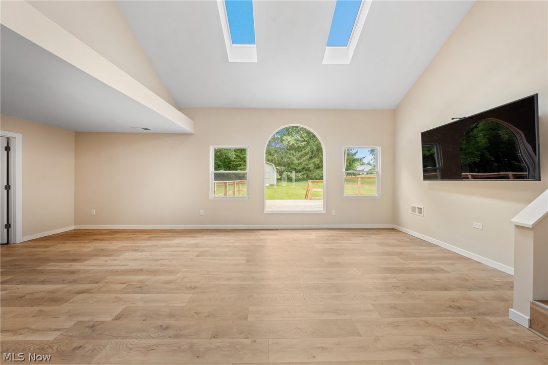 1617 Graham Road Stow, OH 44224 - Photo 10 of 49 Unfurnished living room with lofted ceiling with skylight and light wood-type flooring