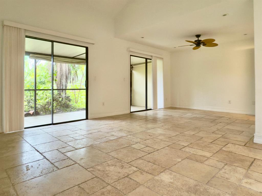 10253 Riverbend Terrace Boca Raton, FL 33498 - Photo 11 of 33 an empty room with windows and ceiling fan