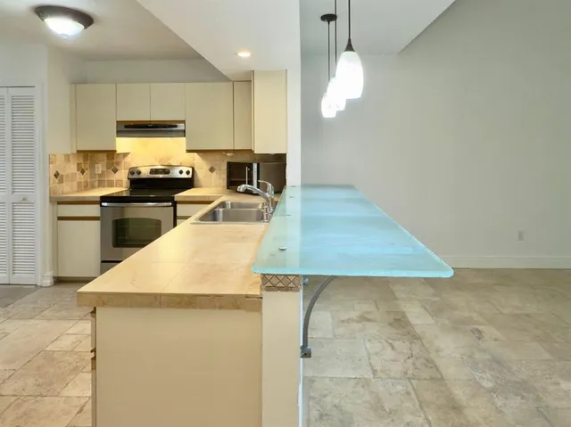 a kitchen with a sink a stove and refrigerator