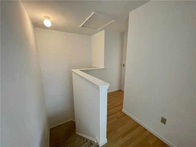 a view of hallway with wooden floor