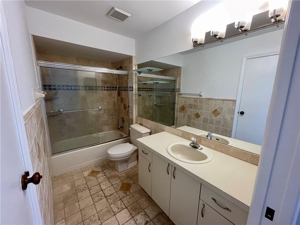 10253 Riverbend Terrace Boca Raton, FL 33498 - Photo 21 of 33 a bathroom with a sink a toilet and shower
