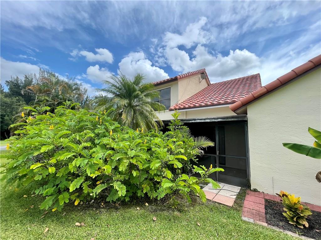 10253 Riverbend Terrace Boca Raton, FL 33498 - Photo 27 of 33 a view of a house with a flower garden