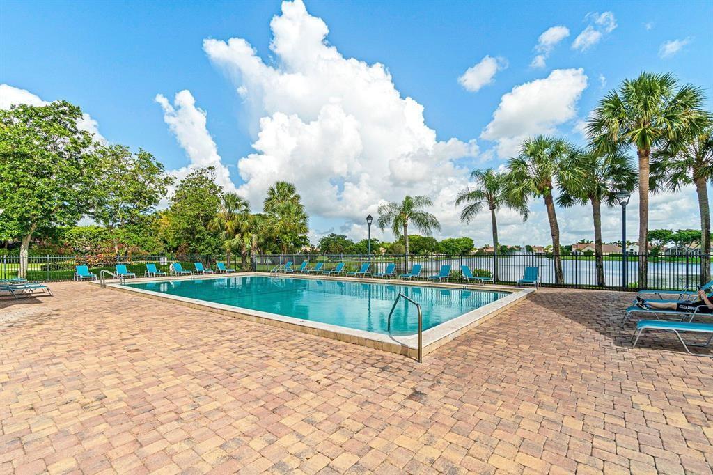 10253 Riverbend Terrace Boca Raton, FL 33498 - Photo 31 of 33 a view of a swimming pool with a yard and potted plants