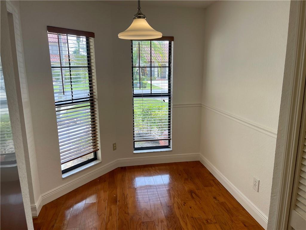 10253 Riverbend Terrace Boca Raton, FL 33498 - Photo 6 of 33 a view of an empty room with wooden floor and a window