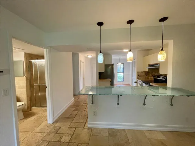 a view of a living room and kitchen view