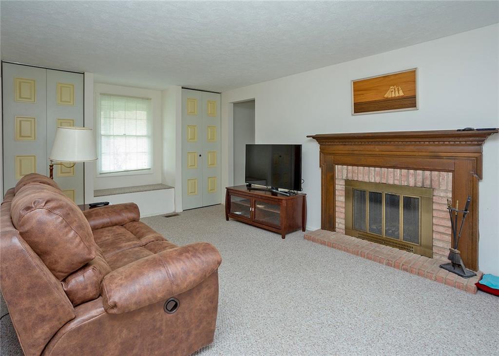 5876 Claridge Export Road Export, PA 15632 - Photo 3 of 25 The family room offers storage and a gas log burning fireplace with wood mantle.