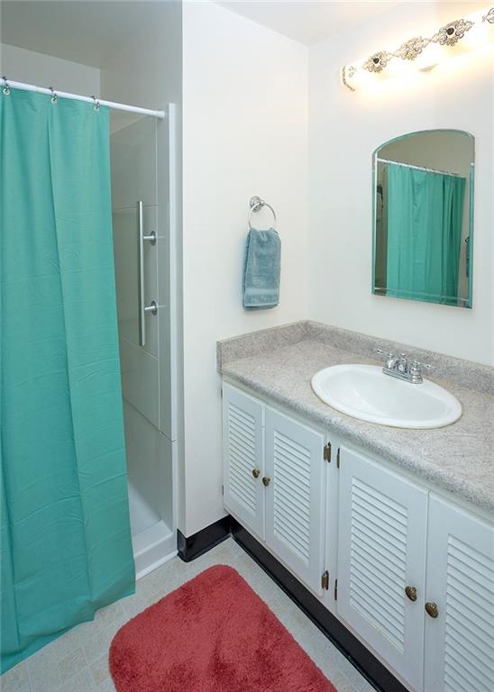 5876 Claridge Export Road Export, PA 15632 - Photo 21 of 25 The master bathroom offers a large storage vanity and a walk-in shower.