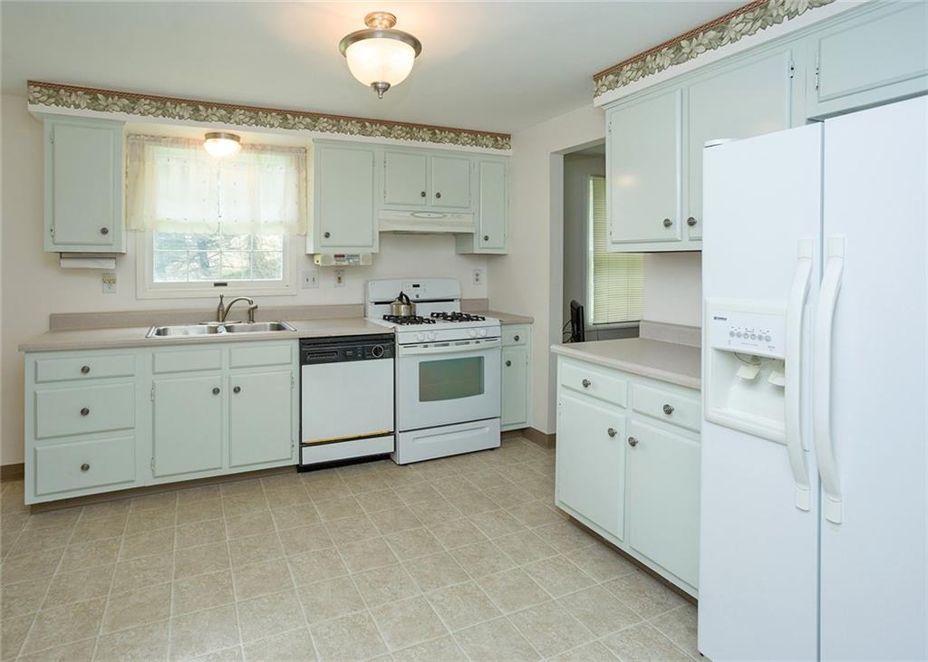 5876 Claridge Export Road Export, PA 15632 - Photo 8 of 25 The fully equipped kitchen offers a gas range and refrigerator with ice and water.