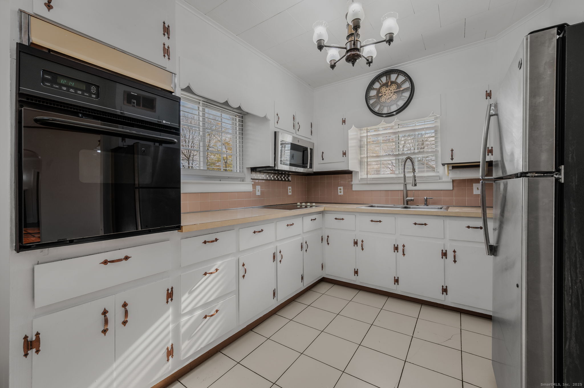 139 Pennsylvania Avenue East Lyme, CT 06357 - Photo 12 of 28 a kitchen with granite countertop white cabinets stainless steel appliances and wooden floor