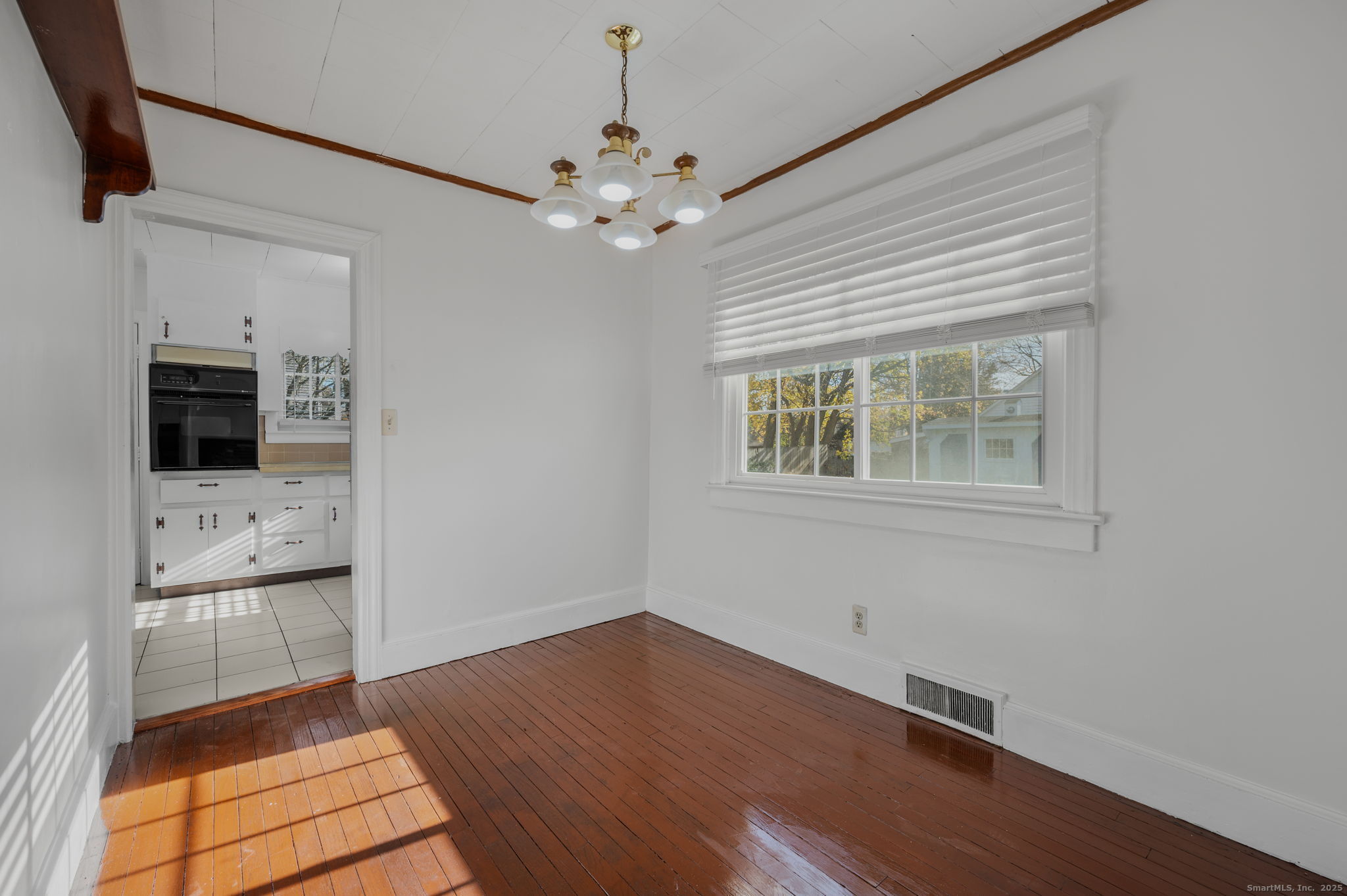 139 Pennsylvania Avenue East Lyme, CT 06357 - Photo 10 of 28 a view of an empty room with a window and wooden floor